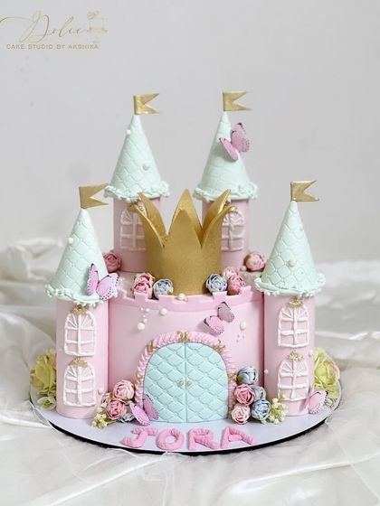 Our princess castle cake, perfect for your little one's special day. The pink and mint colors, along with the golden crown, create a fairytale look.