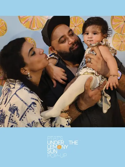 A beautiful family moment with a baby at the PTAT pop-up. Our high-quality cameras and lighting ensure even the youngest guests look great in photos.
