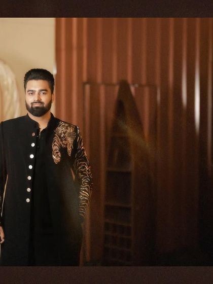 A classic, well-lit portrait of the groom in his engagement attire, looking sharp and ready for the celebration.
