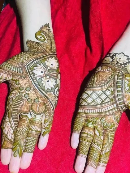 This image shows two different styles I can create. One hand has a modern floral design, while the other features a more traditional geometric pattern, showcasing my versatility.