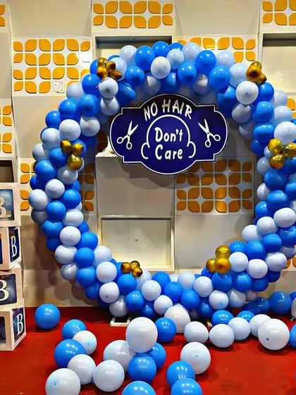 I also provide decorations for traditional Indian ceremonies like the mundan. This fun setup for a baby boy's first haircut includes a "NO HAIR Don't Care" sign inside a blue and white balloon ring, along with "BABY" blocks for a playful touch.