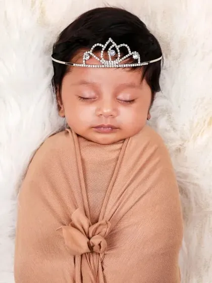 A simple swaddle paired with a delicate tiara. This portrait shows how a single, elegant prop can add a touch of magic to a classic shot.