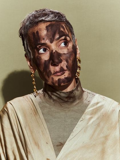 A close-up of the expressive, mud-splattered makeup look from the Huemn show.