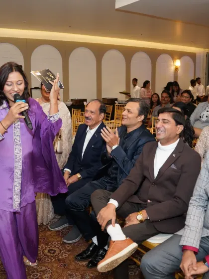 Taking the mic to the audience to get everyone involved in a fun game during an anniversary party. The more the guests participate, the more memorable the event.