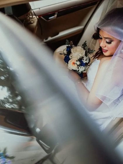 A beautiful portrait of the bride sitting in her wedding car, a moment of calm before the ceremony.