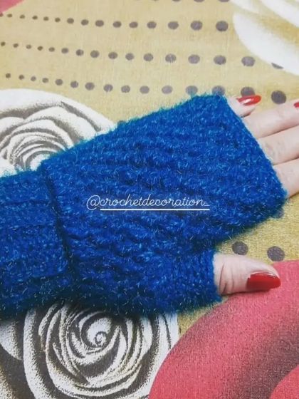 Our cozy fingerless hand warmers, crocheted with a soft, fuzzy blue yarn. These gloves are designed to provide warmth and comfort for your hands during cooler weather.