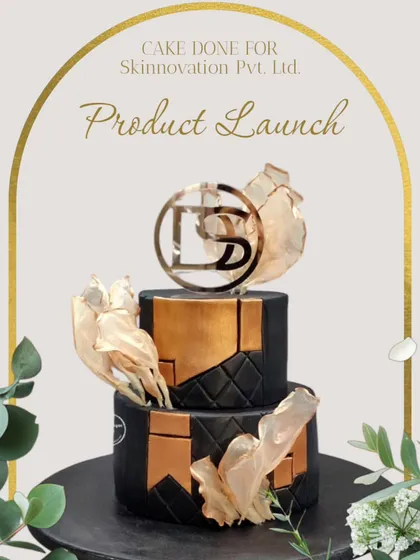 This elegant two-tiered cake was the highlight of a corporate product launch for Skinnovation Pvt. Ltd. The design incorporates the company's logo and brand colours with sophisticated elements like edible gold leaf and a geometric pattern.
