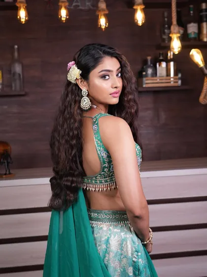 A back view of the deep wave hairstyle, showing how the floral accessory adds a touch of softness to the otherwise bold and textured look.