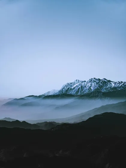 layers of mountains in the haze. the subtle shifts in tone and color are what create a sense of depth and calm.