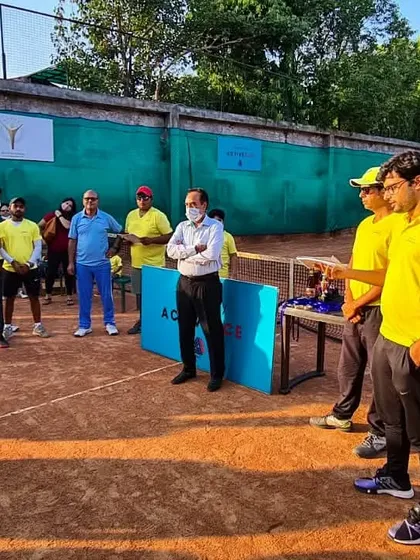 The coaching team listening to an address during an academy event on our clay courts.