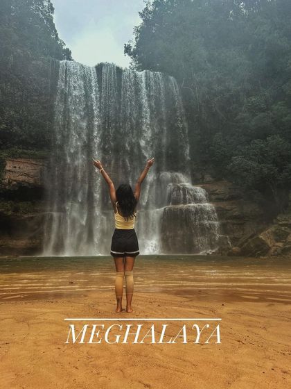 A moment of freedom in front of a waterfall in Meghalaya. We believe travel is about finding these moments of pure joy and connection with nature.