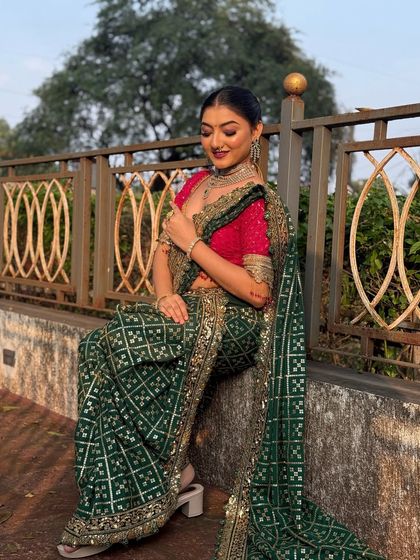 A candid moment of the model looking down. The hairstyle is perfectly neat, showcasing the clean lines of the low bun.