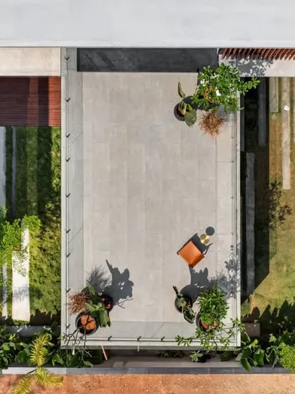 A top-down view illustrating the geometric precision of our landscape and architectural design. The composition includes a central terrace, a green courtyard, and linear paving that guides movement and connects the built form to the garden.