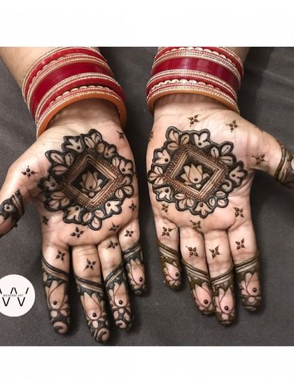 A lovely mandala design created for my mom, perfect for any festive occasion. The red bangles complete the traditional look.