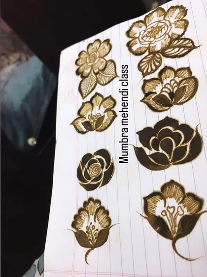 A collection of different flower designs on a practice sheet. Each one requires a slightly different technique to master.
