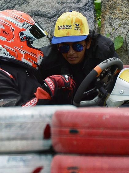 A coach debriefs a driver after a crash. Learning from mistakes and understanding what happened is a crucial part of a driver's development and mental resilience.