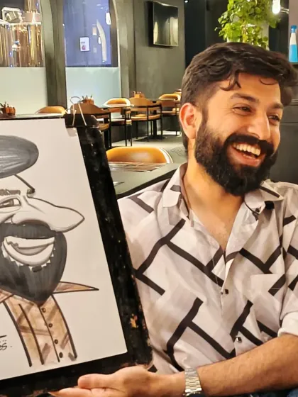 A guest with a great beard and a great smile, and a caricature to match. Drawing at Nincasa is always a lively experience.