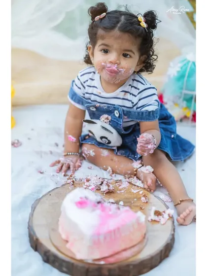 A first birthday isn't complete without a little bit of mess. This cake smash session was all about fun, as little Nitya enjoyed her very own birthday cake. These are the playful, personality-filled moments families cherish.