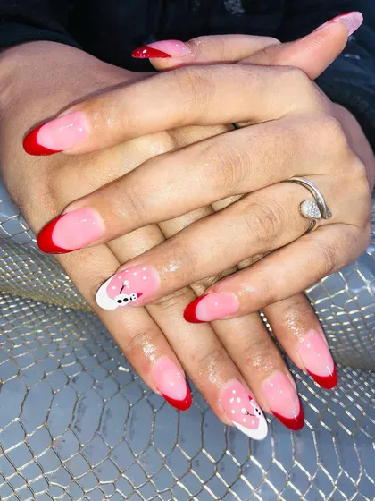A festive Christmas design with a red French tip and cute snowman art.