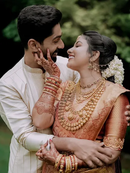 An intimate portrait of a couple, showcasing the deep connection and the intricate beauty of South Indian wedding attire and henna. I focus on capturing these quiet, heartfelt exchanges.