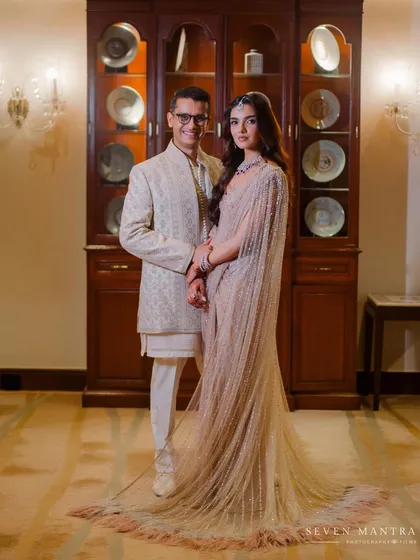 A modern, elegant couple's portrait. I styled the bride in a stunning beige cape saree by Ejaaz Couture, a contemporary choice that exudes sophistication, perfectly complemented by the groom's classic bandhgala.