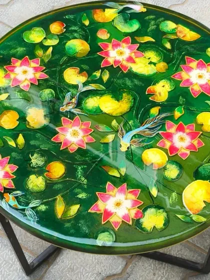 This vibrant lotus pond table is a perfect example of how I turn nature into art. Each lotus flower and koi fish is carefully placed within layers of green-tinted resin to create a sense of depth and tranquility. It’s a functional centerpiece that brings a feeling of peace to your home.
