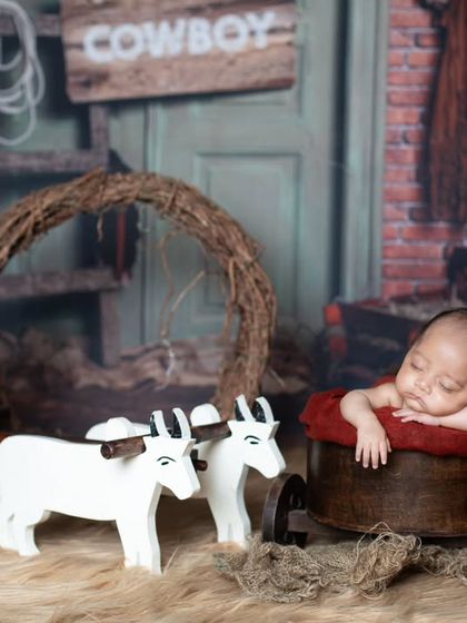 Howdy, partner! This little cowboy is resting in his wagon after a long day on the ranch.