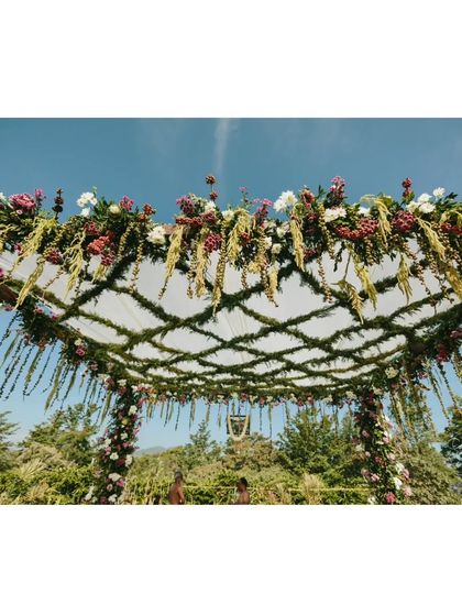 A wider view of the mandap canopy, showcasing the unique and sustainable design that incorporates elements personal to the couple.