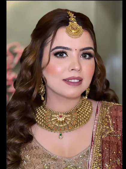 A beautiful smiling portrait, showcasing the complete look with the traditional maang tikka and jewellery.