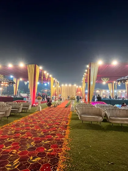 A long, inviting pathway flanked by comfortable lounge seating, leading towards the main event area.