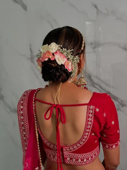 A full view of the floral bridal bun, a timeless and romantic choice for any bride.