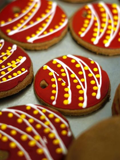 Our brightly decorated Christmas bauble cookies are a festive delight. These gingerbread cookies are covered in red icing with intricate white and yellow piping, making them a beautiful addition to any holiday spread.
