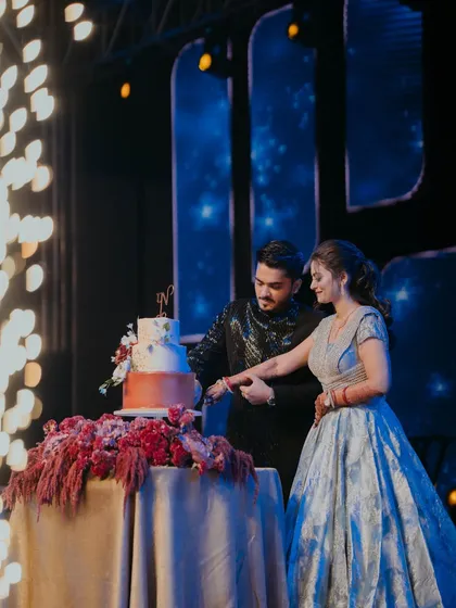 The cake-cutting ceremony, illuminated by sparklers, during a glamorous Sangeet night. We ensure every key moment is celebrated in style.