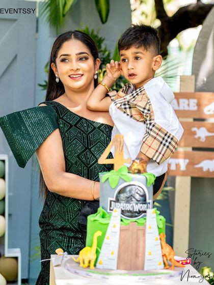 A happy client photo with the birthday boy and his incredible Jurassic World cake.