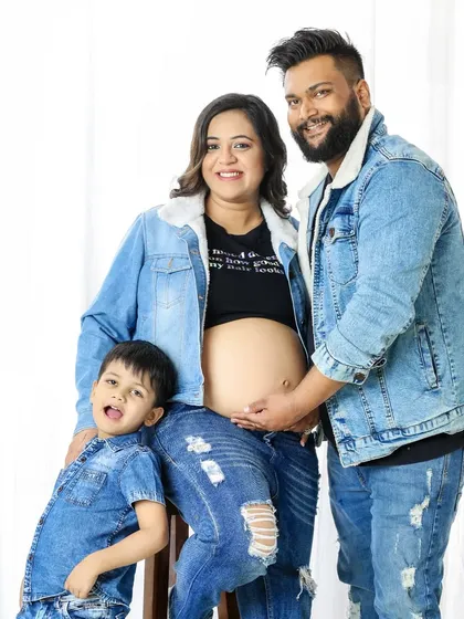 Welcoming a new baby is a family affair. This maternity session includes the older sibling, capturing the excitement of the entire family. The coordinated denim outfits create a fun, casual, and unified look for this growing family's portrait.