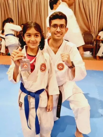 A moment of celebration between a student and his instructor. These relationships are built on trust, respect, and a shared passion for karate.