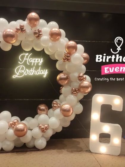 Celebrating 60 in style. This elegant setup features our marquee numbers next to a white and rose gold balloon hoop, accented with dried palm leaves.