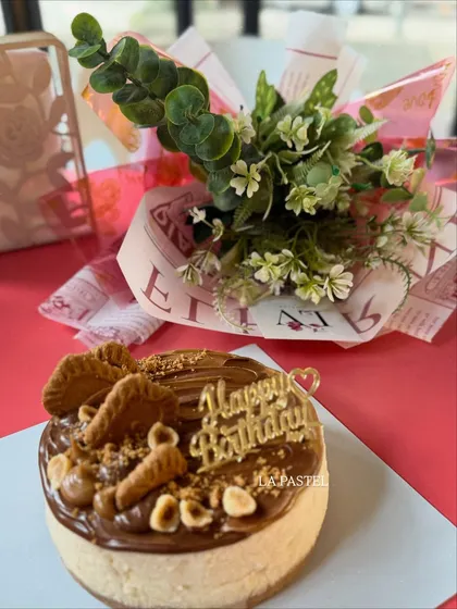 An overhead shot of the Nutella and Biscoff cheesecake, showing the delicious toppings of crushed cookies and hazelnuts.