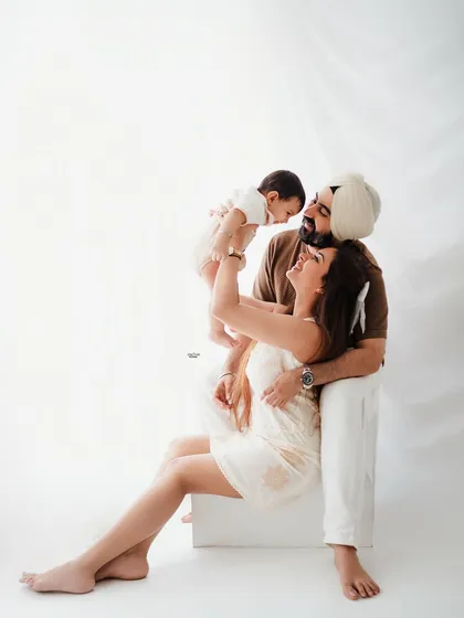 A playful family moment, with dad lifting the baby high in the air. Pure happiness!