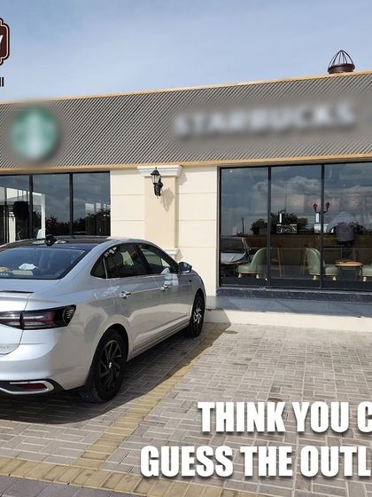 Can you spot the iconic coffee shop? It's a popular meeting point for drivers to park their rides and grab a brew.