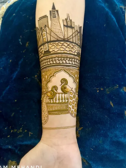 The finished cityscape design, now part of a larger arm piece with traditional peacock motifs below it. This shows how I build designs layer by layer.