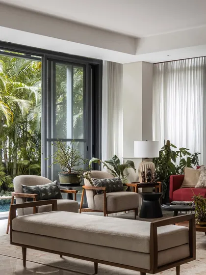 This wide view shows the complete living arrangement, with a daybed and armchairs creating multiple conversation zones. The space is designed to be flexible for both intimate family time and larger gatherings.