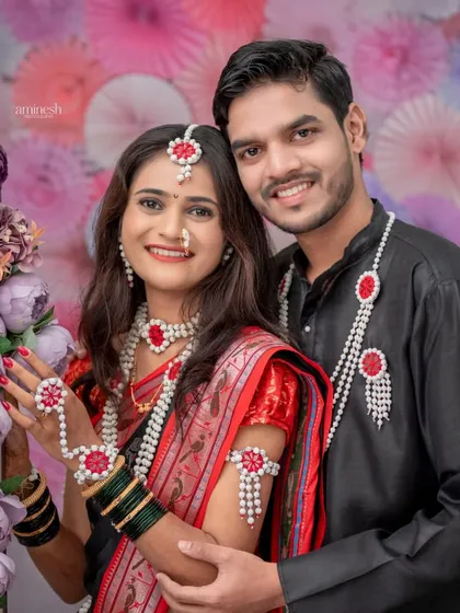 A lovely couple portrait against a vibrant, festive background. Their coordinated outfits and happy smiles make this a perfect memory.