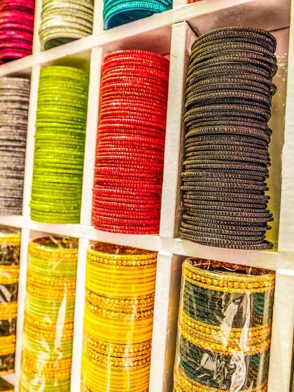 A vibrant display of colorful bangles, a classic element of Indian weddings, ready for the guests to enjoy.