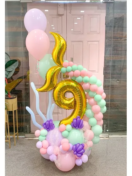 A magical mermaid-themed arrangement for a 9th birthday. The golden mermaid tail and number '9' are surrounded by a pastel wave of balloons, perfect for any child who dreams of the sea.