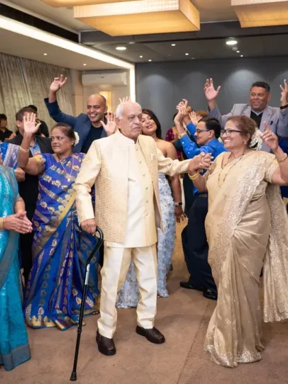 The happy couple on the dance floor, surrounded by their friends and family, celebrating 50 years of love and partnership.
