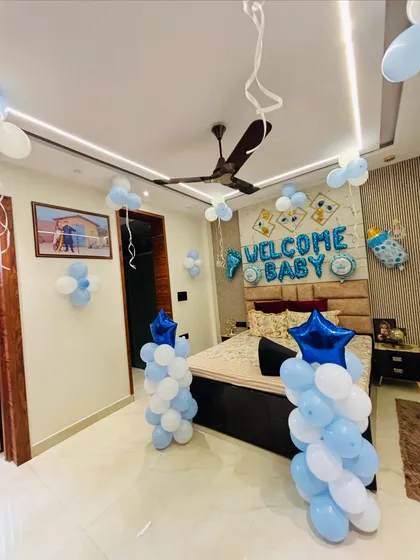 A wide-angle view of the blue and white 'Welcome Baby' room decoration.