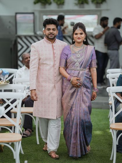 A couple walks down the aisle during their baby shower event. The photo captures them as they are greeted by guests, showcasing the layout of our seating area.