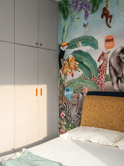 A close-up of the jungle wallpaper, which adds a burst of color and imagination to the room. The design is all about creating a cozy and inspiring atmosphere for a child.