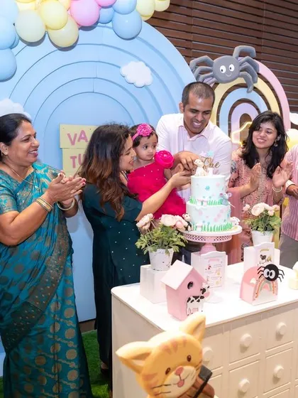 The whole family gathers around for the cake cutting ceremony at a first birthday party. Capturing these multi-generational moments of celebration is what makes small event photography so special for us.